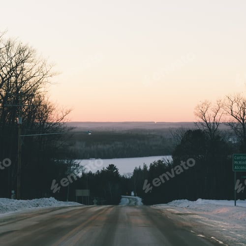 Preview: Winter Road through a Forest at Sunset