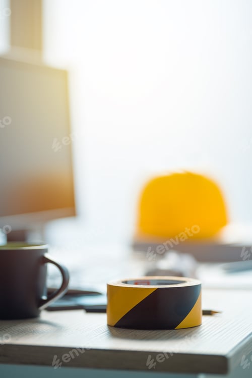 Preview: Under construction tape on office desk