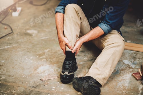 Preview: Senior caucasian man has an accident while working in wood workshop