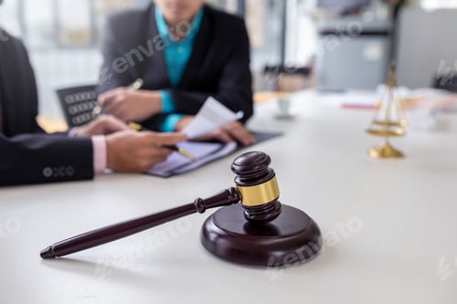 Preview: Businessmen and lawyer discuss lawsuits in the office.