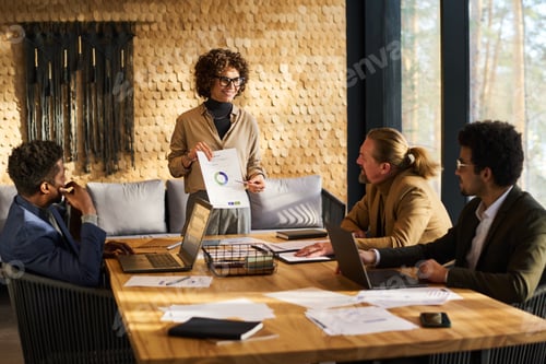 Preview: Confident business coach pointing at financial document