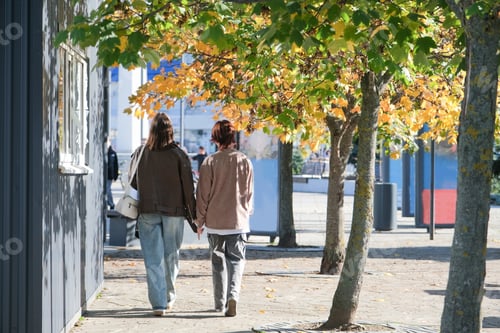 Preview: happy mother with her daughter walking in autumn street