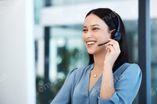 Preview: Shot of a young call centre agent working on a computer in an office
