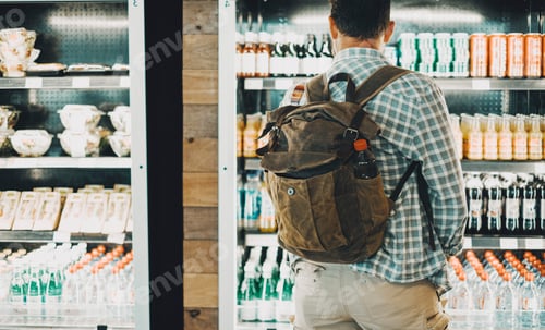 Preview: Traveler backpack man in front of a drinks and food window store. People and travel lifestyle buying