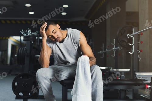 Preview: Muscular African-American Bodybuilder Having Rest After Heavy Deadlifts In Modern Fitness Center