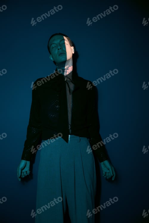 Preview: Handsome young man showcasing unique style with artistic lighting in urban setting