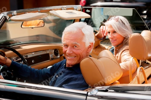 Preview: Portrait of a smiling senior couple sitting in a convertible car