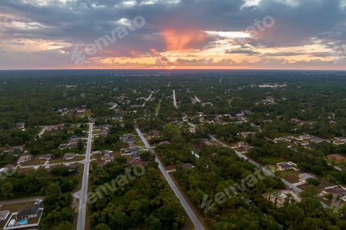 Preview: Aerial view of suburban landscape with private homes between green palm trees in Florida