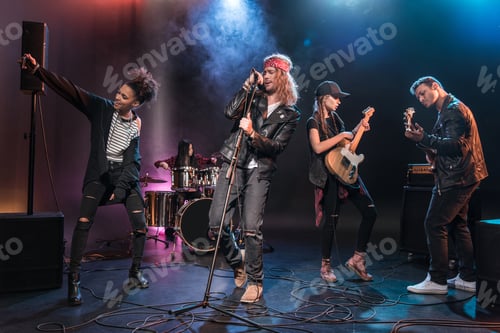 Preview: Young multiethnic rock and roll band performing music on stage