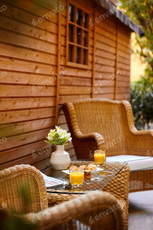 Preview: A table in the courtyard is served for Breakfast and decorated with a vase of flowers