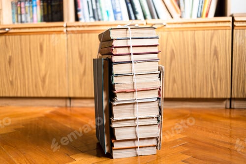 Preview: stack of used books tied with packthread on floor