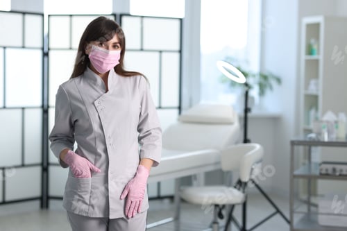 Preview: Cosmetologist in medical uniform in clinic, space for text