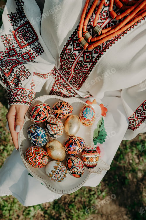 Preview: Ukrainian woman holding in hands Easter eggs. Beautiful geometric slavic decoration.