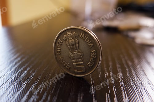 Preview: Closeup shot of five Indian rupees coin on a wooden surface