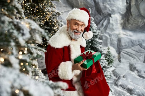 Preview: Santa Claus joyfully prepares gifts in a winter wonderland setting during the festive season