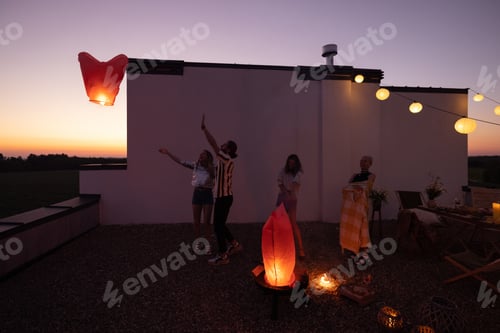 Preview: People launch sky lanterns on the roof