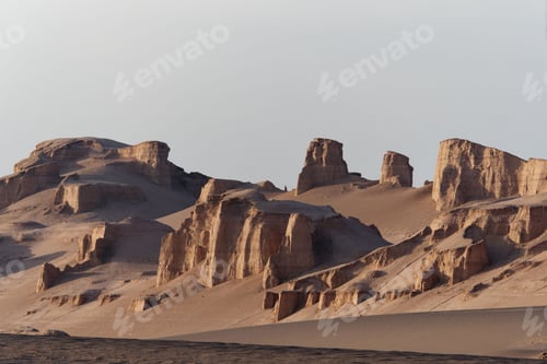 Preview: Stunning view of the desert featuring several mounds surrounded by sand dunes in the foreground