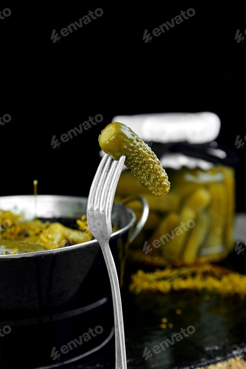 Preview: Canned cucumbers in a metal pan.