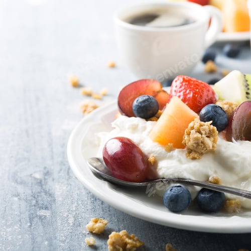 Preview: Yogurt and Fruit Bowl with Coffee in Background