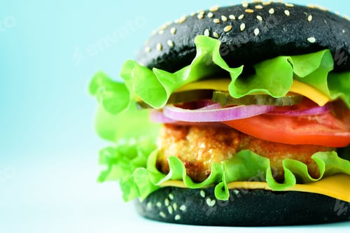 Preview: Delicious burger with beef, cheese, lettuce, onion, tomatoes on yellow background. Close up banner