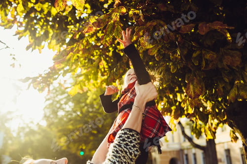 Preview: Mother and little daughter playing in a park