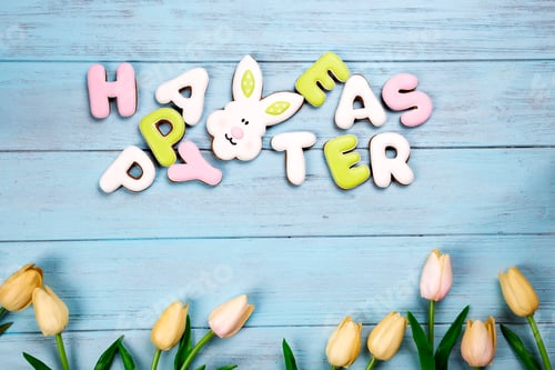 Preview: Happy Easter colorful lettering Happy Easter of ginger biscuits and cookies bunny on wooden blue