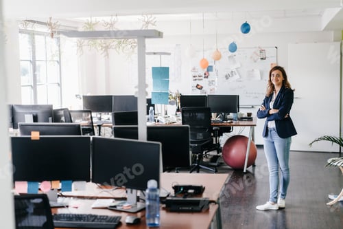 Preview: Confident businesswoman standing smiling in office
