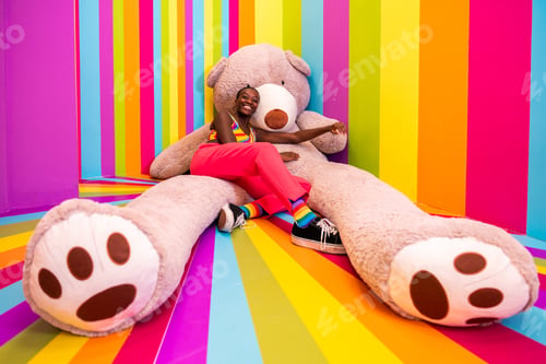 Preview: Beautiful young woman having fun inside a rainbow box room