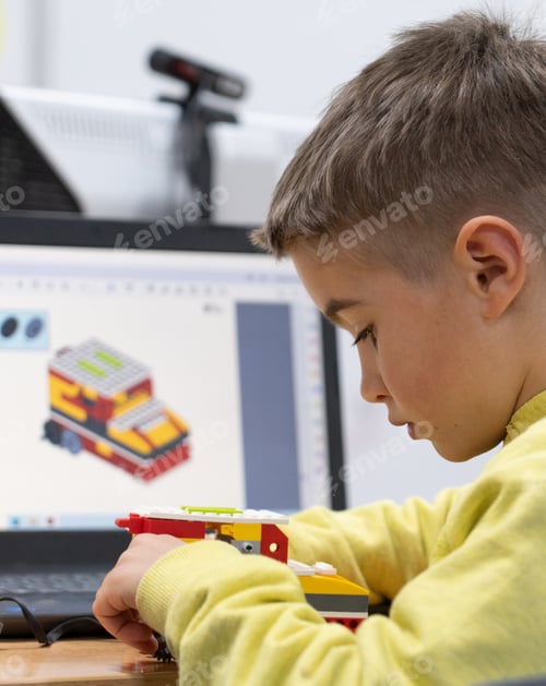Preview: Boy building a robot in robotics class