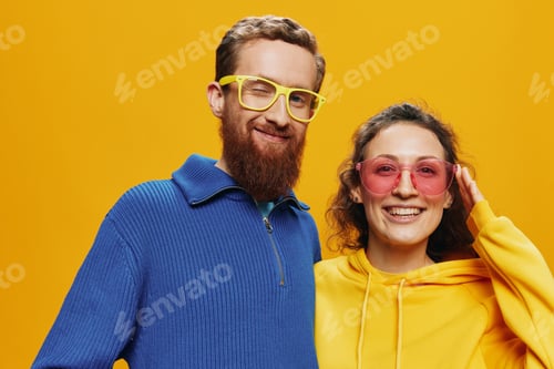 Preview: Man and woman couple smiling cheerfully and crooked with glasses, on yellow background, symbols