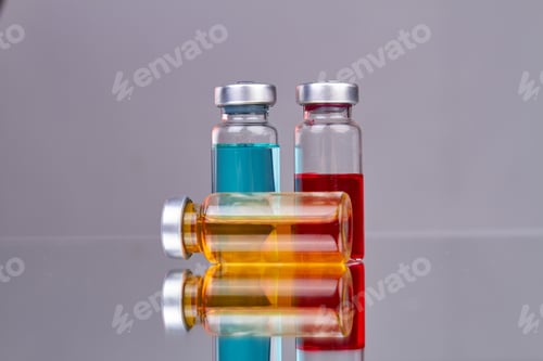 Preview: Collection of glass drug vials with colored medicine.