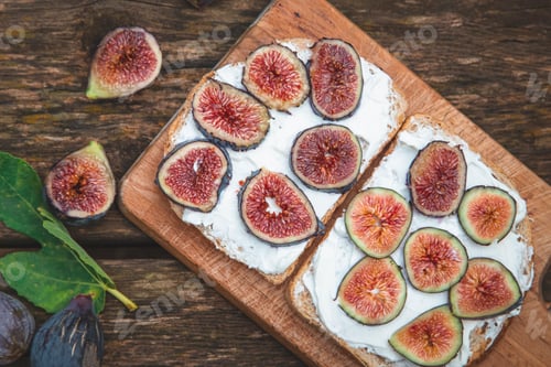 Preview: Cream cheese with figs on bread served on wooden board