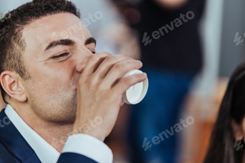 Preview: Portrait of Caucasian businessman drinking water