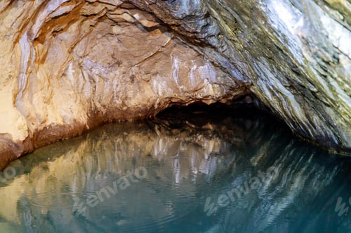 Preview: Boat on underground lake of bright blue color in a mountain