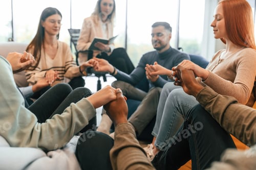 Preview: Calm and cheerful atmosphere. Group of people are having therapy meeting together
