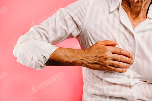 Preview: An horizontal shot of an old woman resting palm on chest