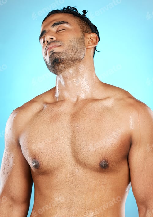 Preview: Relax, skincare and man in shower, water splash and studio for grooming, wellness and hygiene on bl