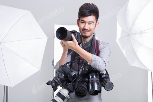 Preview: Photographer taking picture with many cameras hanging on his neck