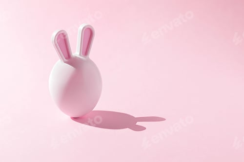 Preview: Easter egg with rabbit ears on pink background with copy space.