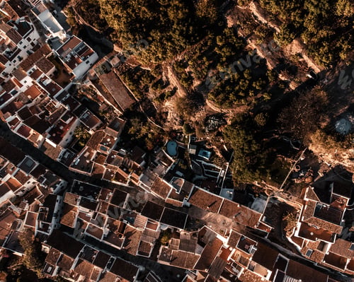 Preview: Aerial view of building roofs and a hillside with lush greenery. Frigiliana, Malaga, Spain.