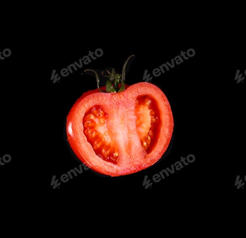 Preview: The red tomato cut half-and-half on a black background. Kind with a side.