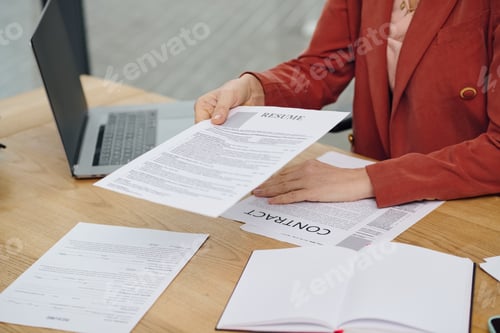 Preview: Deeply Analyzing Potential: Woman Reviewing Resume