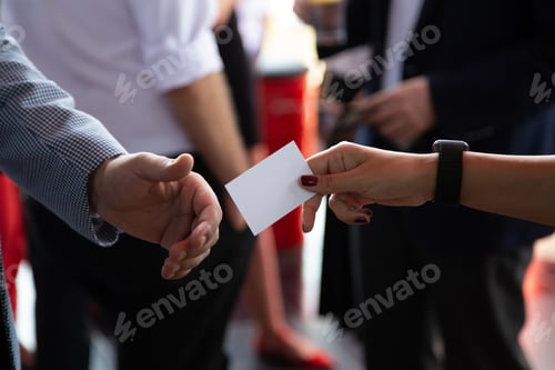 Preview: Confident female professional is offering a business card during a business meeting