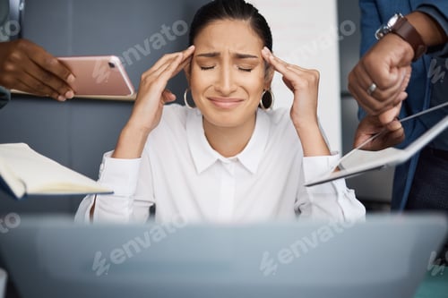 Preview: Shot of a young businesswoman looking stressed out in a demanding office environment