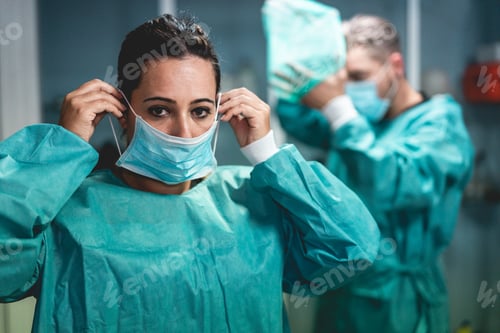 Preview: Doctors and nurse preparing to work in hospital for surgical operation