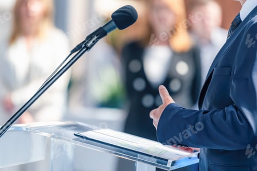 Preview: Male politician at press conference delivers a compelling vision, engaging media