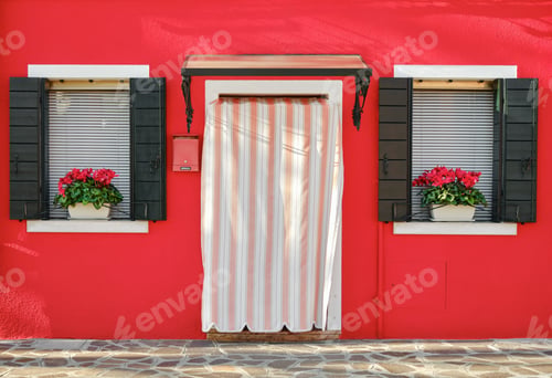 Preview: Traditional colorful home entrance with two windows in Burano