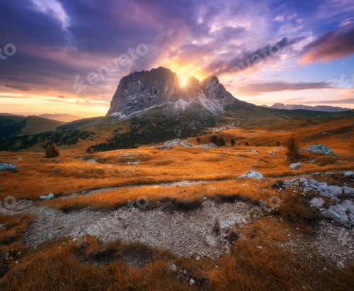Preview: Mountains and orange alpine meadows at sunset in golden autumn