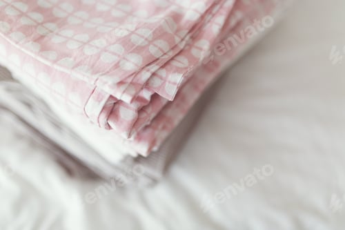 Preview: a stack of clean and ironed linen is on the bed