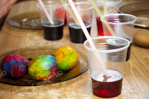 Preview: Easter eggs and colored liquid paints on the table